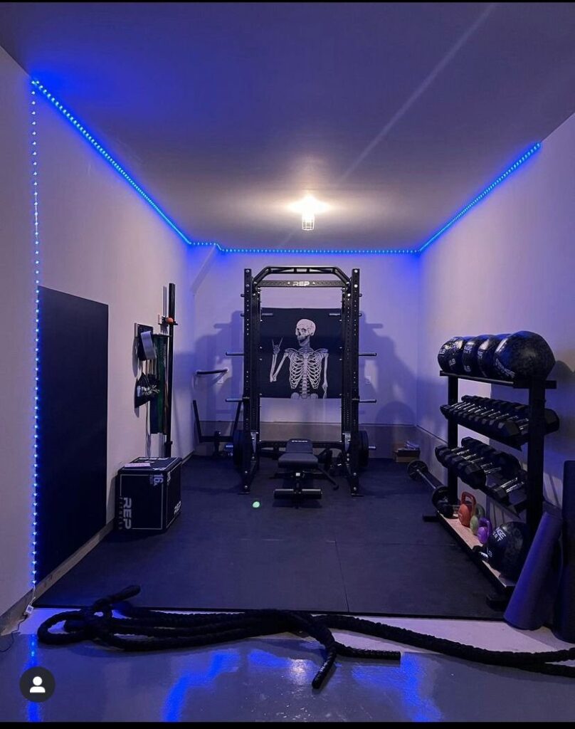 Custom home gym setup with purple LED lighting.