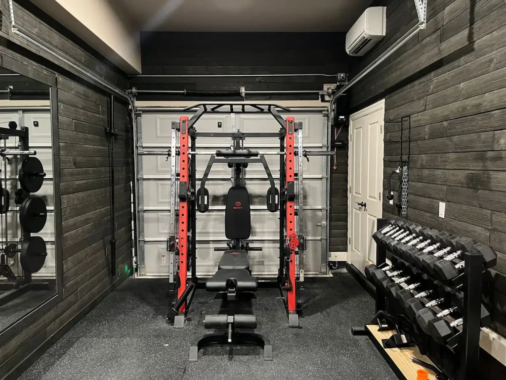 Custom home gym with mirrors, a squat rack, and a weight rack.