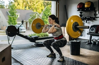 Woman performs a squat workout in her garage gym.